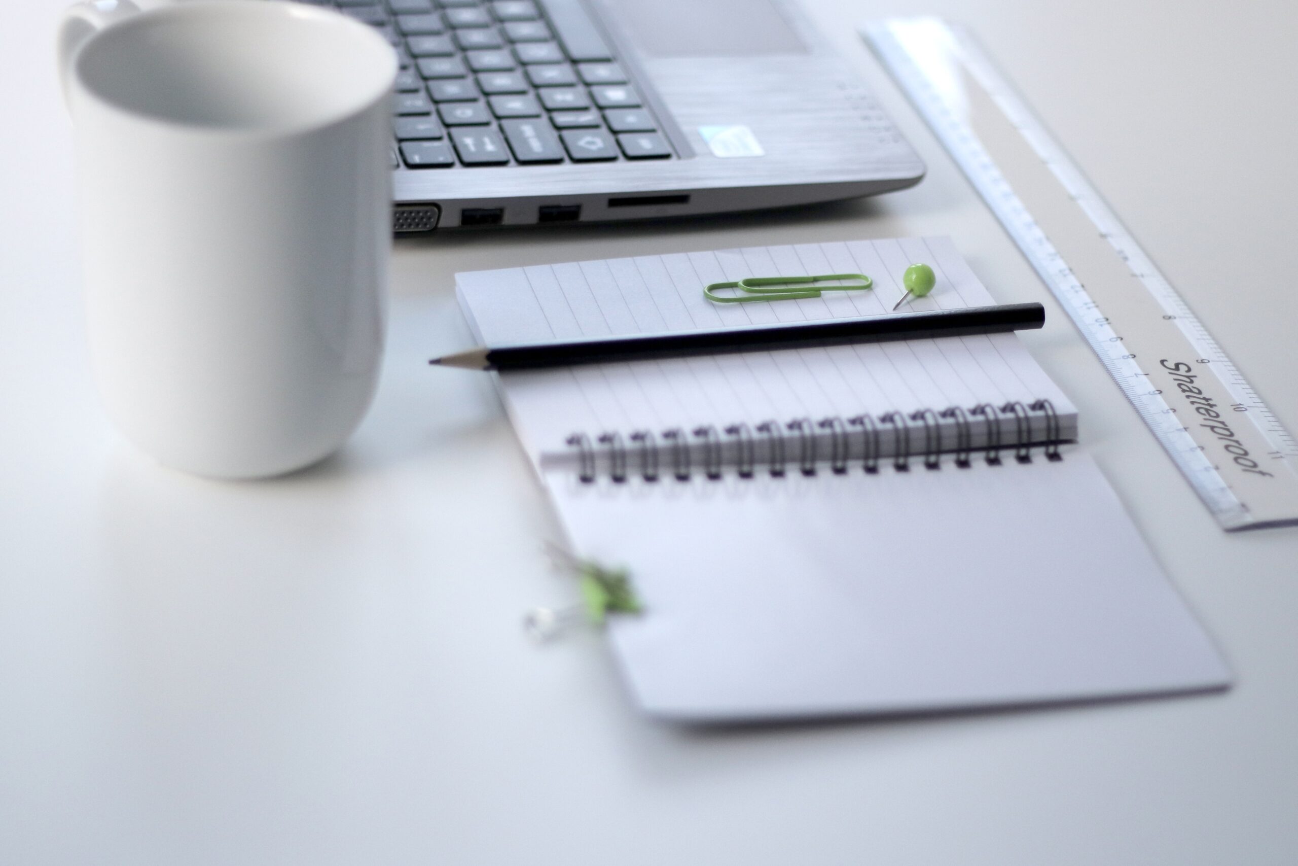 Computer desk with a pen on it, symbolizing AskBecky's executive assistant services, fractional COO support, and business operations expertise.